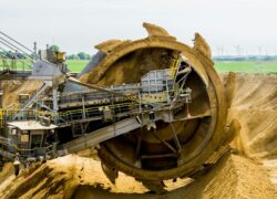 round brown and grey metal heavy equipment on sand