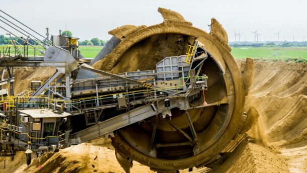 round brown and grey metal heavy equipment on sand